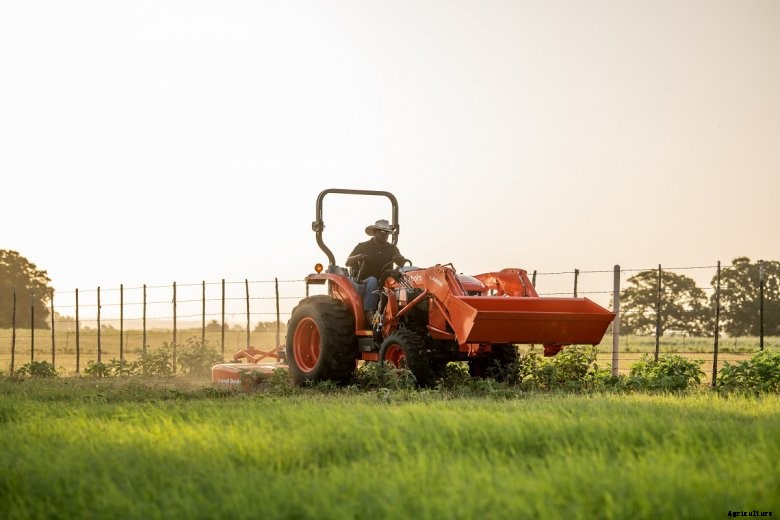 A ROPS model of Kubota&#039;s latest compact tractor drives along a fence line